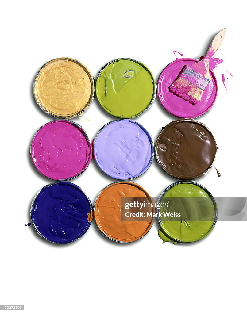 "Lids of paint cans with brush, overhead view"
