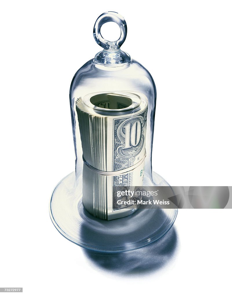 Roll of notes under bell jar
