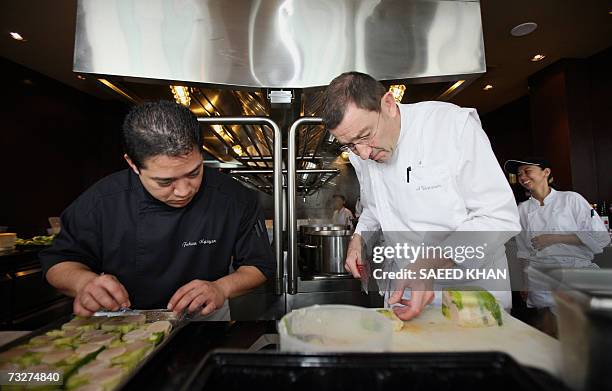 Michelin three star chef Antoine Westerman from France prepares lunch along with an unidentified chef at one of the kitten of Mezzaluna resturant in...