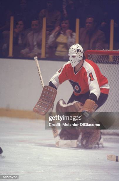 Canadian professional ice hockey player Bernie Parent, goalie of the Philadelphia Flyers, defends the goal during an away game, late 1960s or 1970s....