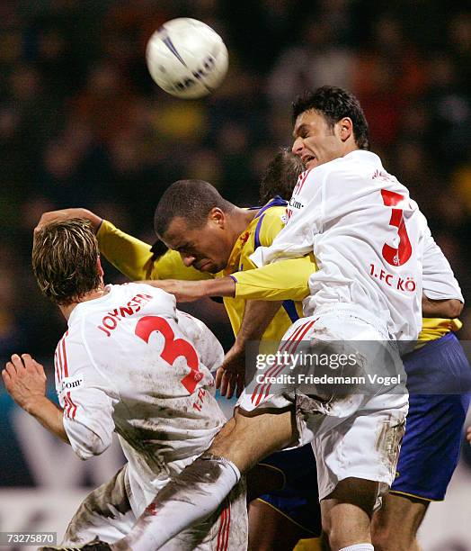 Francis Banecki of Braunschweig tussles for the ball with Marius Johnsen and Fehmi Alpay-Oezalan of Cologne during the Second Bundesliga match...