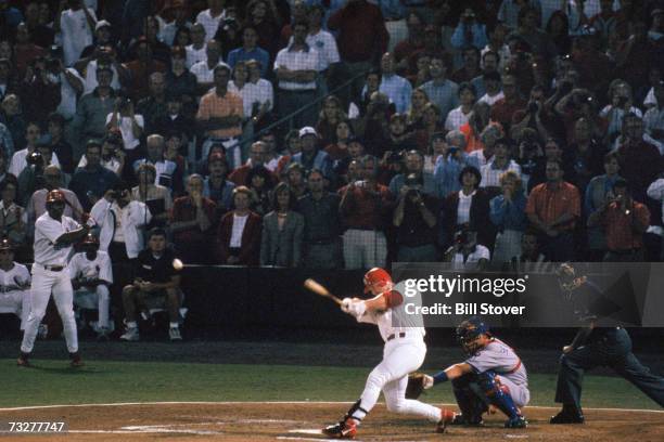 Mark McGwire of the St. Louis Cardinals hits a 341- feet line drive over the left field wall, for his 62nd home run of the year surpassing the...