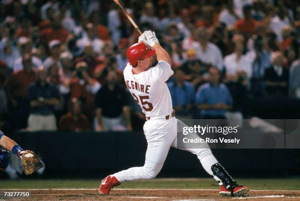 Mark McGwire of the St. Louis Cardinals hits a 341- feet line drive over the left field wall, for his 62nd home run of the year surpassing the...