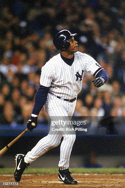 Darryl Strawberry of the New York Yankees watches the flight of the ball as he follows through on his swing during the American League Divisional...