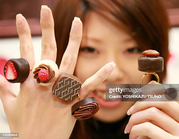 Nami Saeki, a sales clerk of Japan's accesory shop Q-pot shows off assorted chocolate like creations for rings, priced 3,780 yen and 4,200 yen , at...