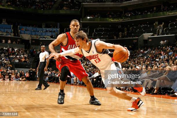 Matt Carroll of the Charlotte Bobcats drives past Ime Okuka of the Golden State Warriors on February 3, 2007 at the Charlotte Bobcats Arena in...