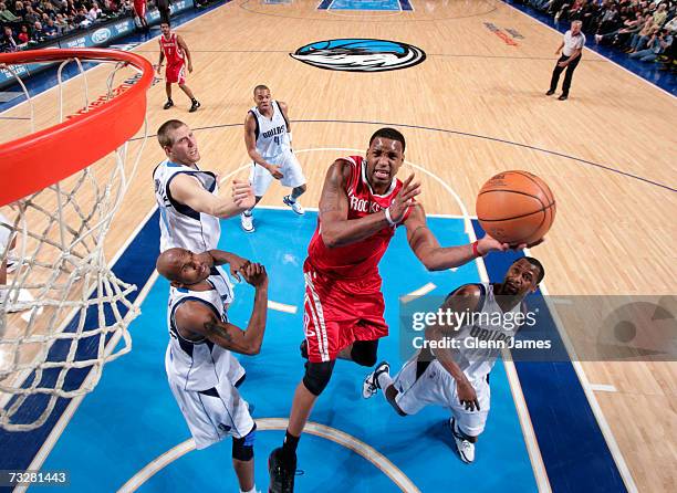 Tracy McGrady of the Houston Rockets goes in for the layup past Jerry Stackhouse and Greg Buckner of the Dallas Mavericks on February 9, 2007 at the...