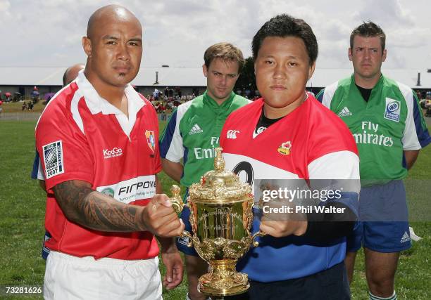 Tonga captain Otenili Latu and Korea captain Tae-Hyung Kim hold the Webb Ellis Cup before the Rugby World Cup 2007 Qualifier match between Korea and...