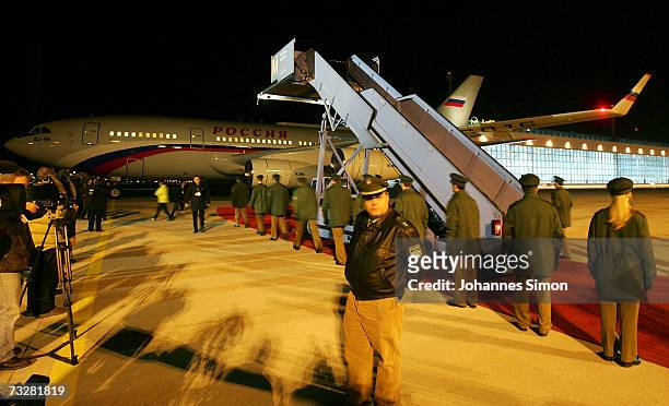 German police wait for Russia's Leader Vladimir Putin to arrive by airplane at the gangway at Franz-Josef-Strauss-Airport on February 9 in Munich,...
