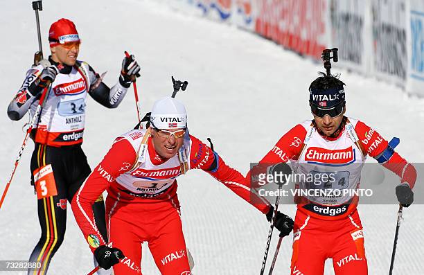 Norwegian Frode Andresen sends off teammate Ole Einar Bjoerndalen in front of German Michael Greis during the Men 4 x 7.5 km Relay race of the...