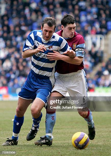 Glen Little of Reading holds off Gareth Barry of Aston Villa during the Barclays Premiership match between Reading and Aston Villa at the Madejski...