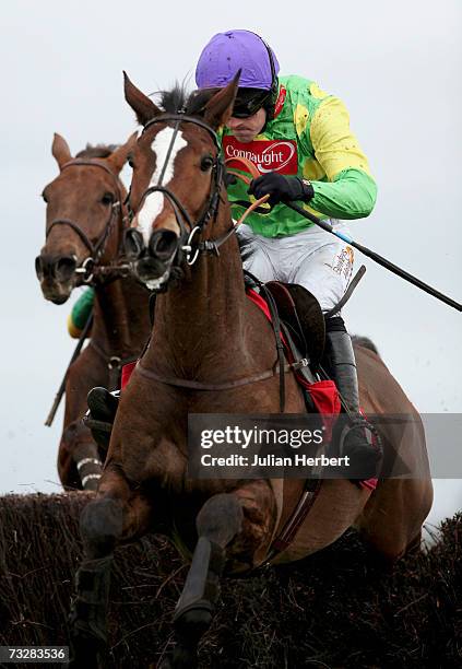 Ruby Walsh and Kauto Star clear the second last fence before landing The AON Steeple Chase Race run at Newbury Racecourse on February 10, 2007 in...