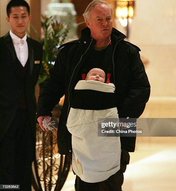 Tourist carrying a baby walks through a hotel February 10, 2007 in Beijing, China. China received 124 million inbound travelers in 2006, ranking...