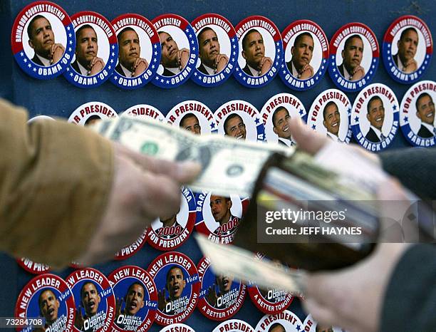 Springfield, UNITED STATES: A vendor sells campaign buttons of US Democratic Presidential hopeful US Senator Barack Obama outside Old Illinois State...