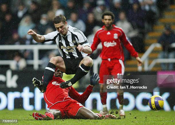 Scott parker straddles the challenge of Momo sissoko during the Barclays Premiership match between Newcastle United and Liverpool at St. James Park...