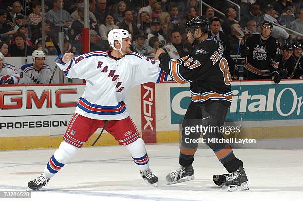 Colton Orr of the New York Rangers gets ready to through a puch during a NHL hockey game against Donald Brashear of the Washington Capitals at the...