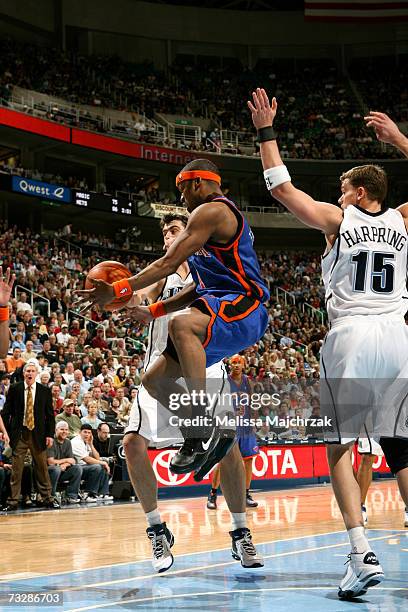 Steve Francis of the New York Knicks makes the pass around Mehmet Okur and Matt Harpring of the Utah Jazz on February 10, 2007 at the EnergySolutions...