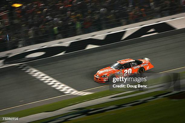 Tony Stewart, driver of the Home Depot Chevrolet, crosses the finish line under caution to win the Budweiser Shootout at Daytona International...