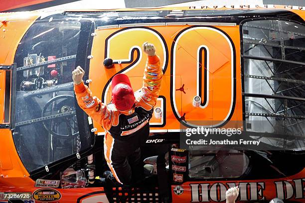Tony Stewart, driver of the Home Depot Chevrolet, celebrates in victory lane after winning the Budweiser Shootout at Daytona International Speedway...