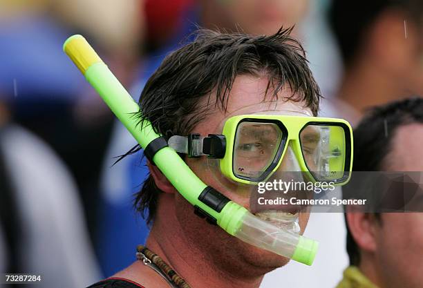 Spectator wears a mask and snorkel during a rain delay in the Commonwealth Bank One Day International Series second final match between Australia and...
