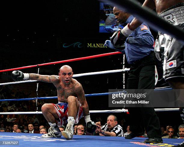 Referee Kenny Bayless watches as Luis Collazo falls down after being hit by Shane Mosley in the 11th round of their interim WBC welterweight title...