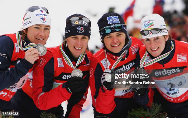 Florence Baverel-Robert, Delphine Peretto, Sylvie Becaert and Sandrine Bailly of France present their silver medal of the Women's 4 x 6 km Relay in...