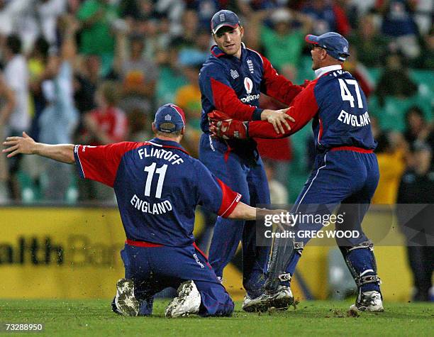 England captain Andrew Flintoff slides onto his knees as he runs in to congratulate teammate Jamie Dalrymple who took a catch to dismiss Australia's...