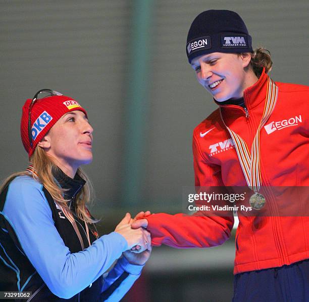 Ireen Wust of Netherlands is congratulated by Anni Friesinger of Germany during the medal ceremony of the World Allround speed skating Championships...