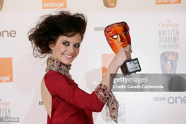 Actress Eva Green poses backstage in the Awards Room with the ORSA award at The Orange British Academy Film Awards at the Royal Opera House on...