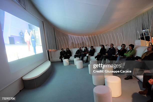 Visitors watch a video during the opening ceremony for the Olympic Museum at Atrium on February 10, 2007 in Turin, Italy.