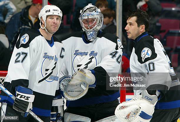 Tim Taylor, Johan Holmqvist, and Marc Denis of the Tampa Bay Lightning celebrate their 4-1 victory against the New Jersey Devils on February 11, 2007...