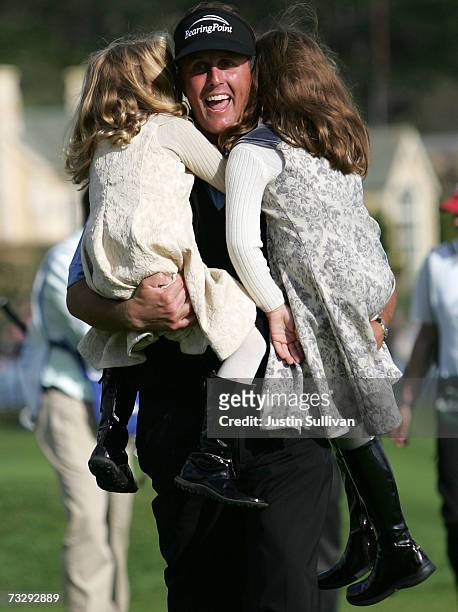 Phil Mickelson lifts his daughters Sophia and Amanda after winning the AT&T Pebble Beach National Pro-Am February 11, 2007 in Pebble Beach,...