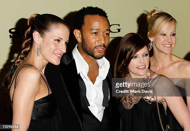 Musicians Emily Robinson, Natalie Maines and Martie Maguire of the Dixie Chicks pose with John Legend as they arrive at the Sony/BMG Grammy party...