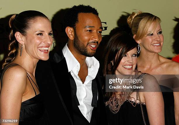 Musicians Emily Robinson, Natalie Maines and Martie Maguire of the Dixie Chicks pose with John Legend as they arrive at the Sony/BMG Grammy party...