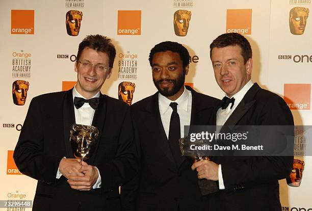 Writer Jeremy Brock, actor Chiwetel Ejiofor and writer Peter Morgan pose backstage with the Adapted Screenplay Award in the Awards Room at the Orange...