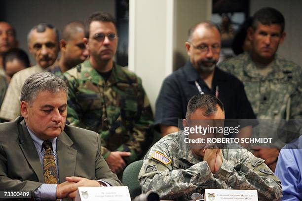 United States Southern Command Sergeant Major Michael Balch joins others in prayer 12 February 2007 in Miami, Florida during a press conference...