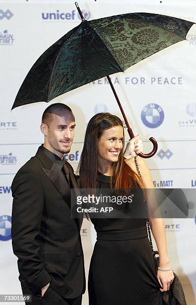 British actor Joseph Fiennes and his partner Natalie Jackson Mendoza pose for photographers as they attend the "Cinema for Peace" gala during the...