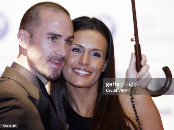 British actor Joseph Fiennes and his partner Natalie Jackson Mendoza pose for photographers as they attend the "Cinema for Peace" gala during the...
