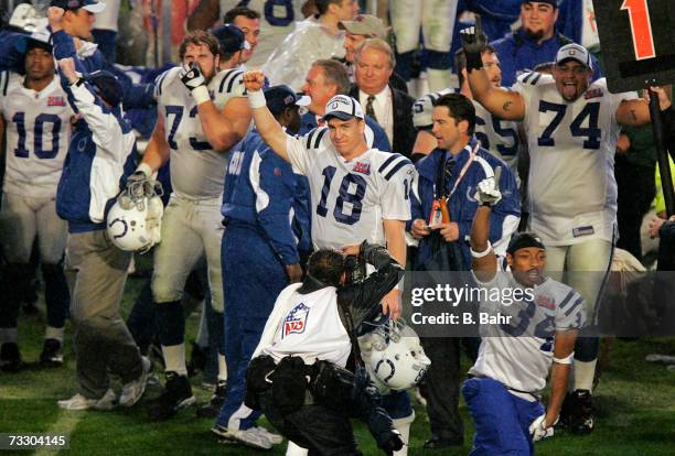 Quarterback Peyton Manning, guard Jake Scott, and tackle Charlie Johnson of the Indianapolis Colts celebrate after defeating the Chicago Bears during...