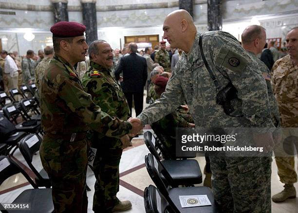 Army General Raymond T. Odierno Commander of Multi-National Corps-Iraq, greets Iraqi military officers during a change of command ceremony, at Camp...
