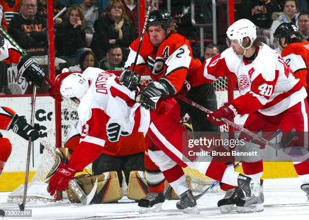 Derian Hatcher of the Philadelphia Flyers hits Pavel Datsyuk of the Detroit Red Wings at the Wachovia Center February 12, 2007 in Philadelphia,...