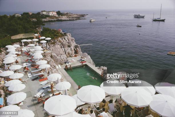 Guests round the swimming pool at the Hotel du Cap Eden-Roc, Antibes, France, August 1969.