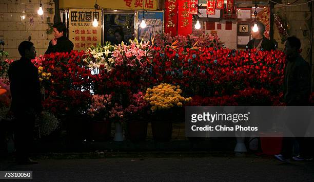 Two vendors wait for customers at a flower shop on February 13, 2007 in Chongqing Municipality, China. As the Valentines Day festival draws near,...