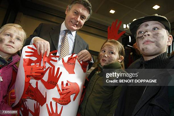 Foreign Minister Karel De Gucht poses with children during a demonstration organized by the Belgian coalition against the use of child soldiers in...