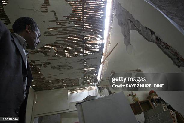 An Algerian man looks at his damaged house following a bomb expolsion that targeted the main building of the National "Gendarmerie" in the Si...