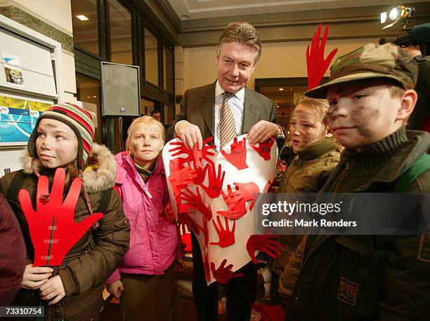 Belgian Minister of Foreign Affairs Karel De Gucht poses for a photograph with 10-12 year old children who support operation Red Hand Day, at the...