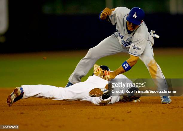 Jose Reyes of the New York Mets slides into second base safely before the tag of Rafael Furcal of the Los Angeles Dodgers during Game One of the...