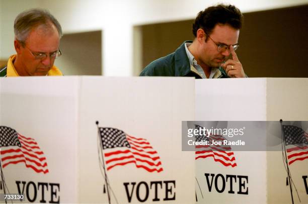 Jim Morrow and Jorge Fitzmaurice cast their ballot for president of the United States in early voting in El Paso, Texas, October 23, 2000. The state...