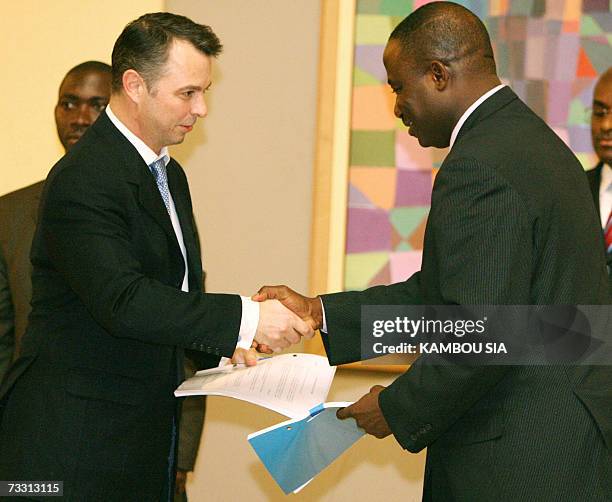 Roald Goethe , spokesman of the Dutch company Trafigura, exchanges documents with Desire Tagro , advisor of Ivory Coast president Laurent Gbagbo, 13...