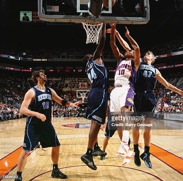 Leandro Barbosa of the Phoenix Suns goes up for a shot against Paul Millsap and Andrei Kirilenko of the Utah Jazz during a game at US Airways Center...